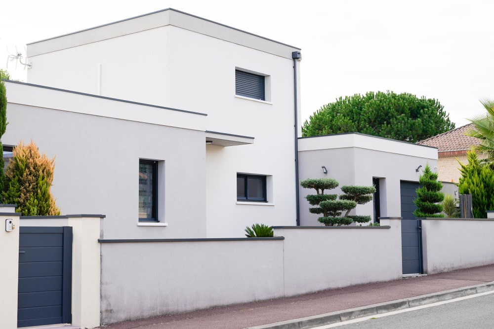 white exterior wall and black windows 