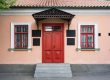 Vintage architecture featuring a classical facade of a building with a striking red door