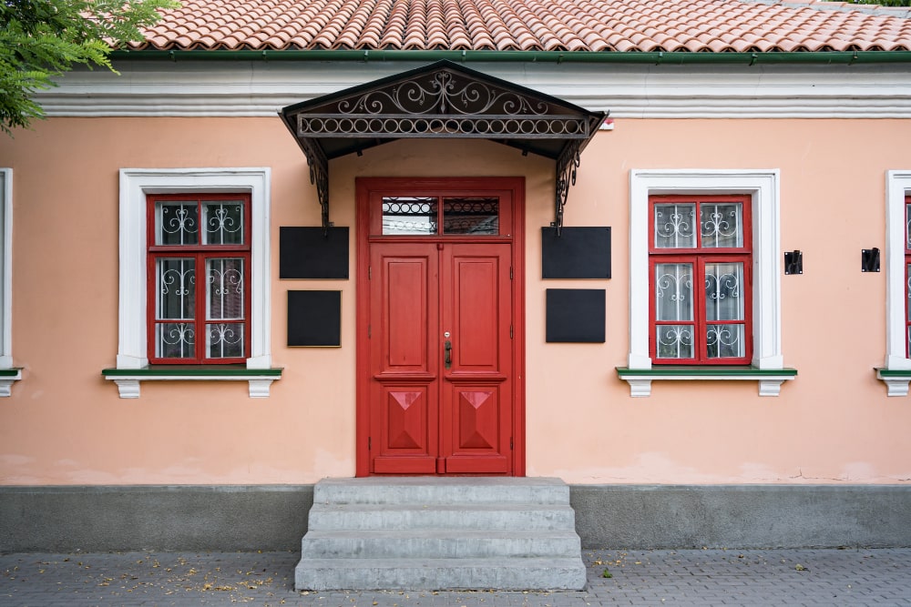 Vintage architecture featuring a classical facade of a building with a striking red door